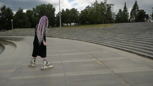 Woman Roller Skating in Urban Park Area