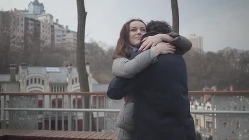 Woman Hugs Man in an Urban Setting