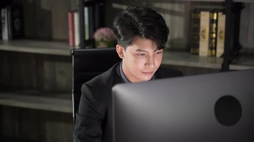 young businessman wearing suit working in business marketing work on computer laptop in home office