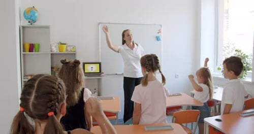 Teacher Leads Children in an Exercise at School