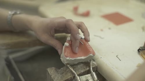 Dental Technician Working on Tooth Mold in Lab