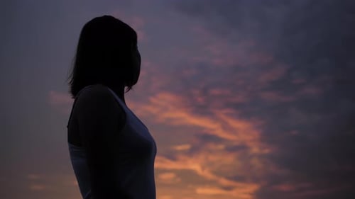 Woman Silhouette Over Sunset Sky Dark Black Shadow of Female Body with Hands Up Teenage Girl Having