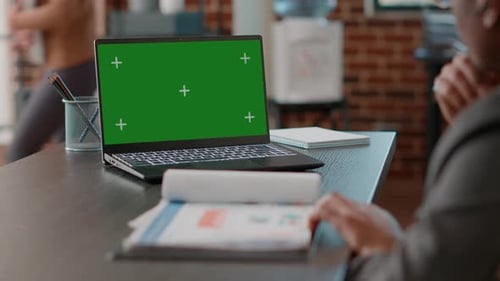 Laptop With Green Screen on Office Desk