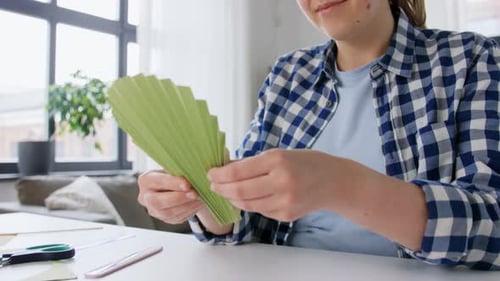 Woman Crafts Paper Fan at Home Crafting