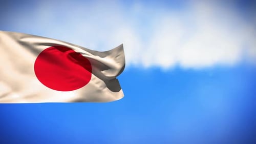 Waving Japanese Flag Against a Blue Sky with Clouds