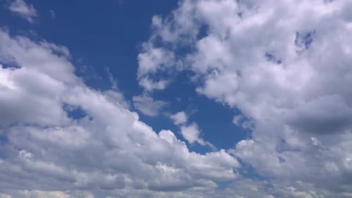 White Cumulus Clouds Drifting in the Blue Sky