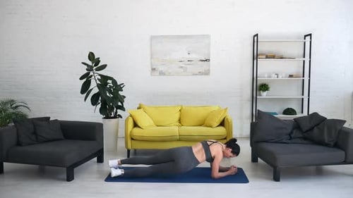 Woman Doing Plank Exercise at Home