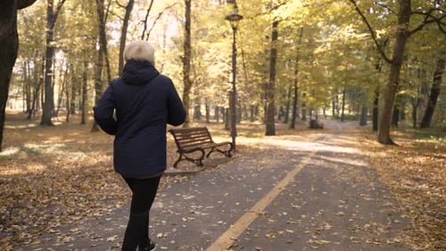 Healthy Elderly Female Enjoying Jogging Outdoors