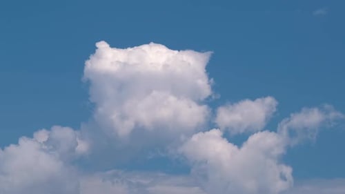 Clouds Drifting Across a Clear Blue Sky