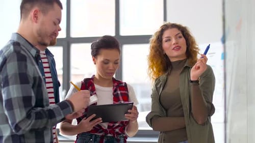 Creative Team with Tablet Pc and Charts at Office