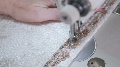 Needle of the Sewing Machine Sews Fabric