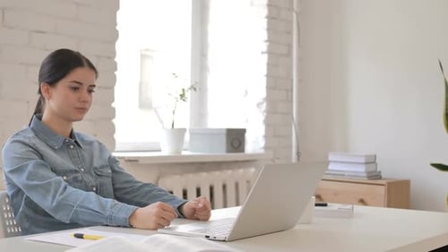 Tired Woman Working at Laptop Computer in Office