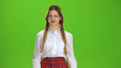Schoolgirl Shows Her Thumb Down. Green Screen