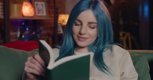 Close Up View of Pretty Young Woman with Blue Hair Reading literature, Millennial Girl Enjoing Book