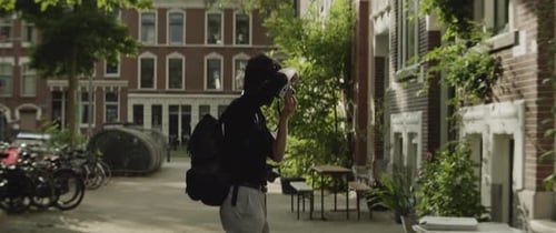 Caucasian man taking photos of building in the city