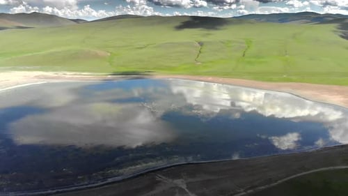 Lake in The Middle of The Treeless Meadow with Aerial View
