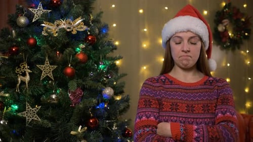 Upset Woman with Christmas Tree and Santa Hat