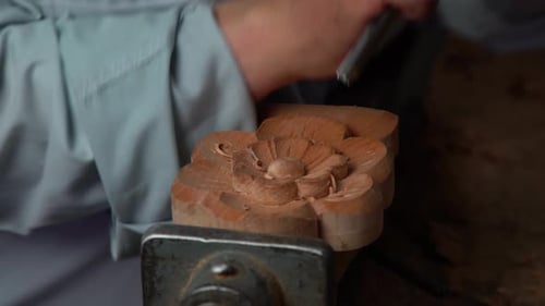 Woodworker Carving Intricate Flower Design with Chisel