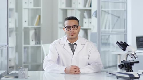 Scientist Explains Research in Bright Lab Setting