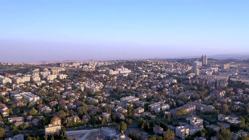 Slow aerial fly over Jerusalem city Israel, purple haze day over the buildings