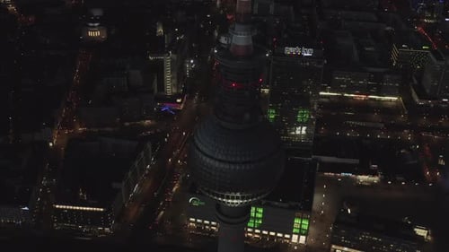 AERIAL: Close Up of Berlin Germany TV Tower Alexanderplatz at Night with City Lights Traffic