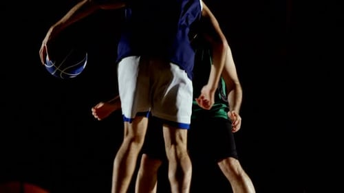 Competitors playing basketball in the court