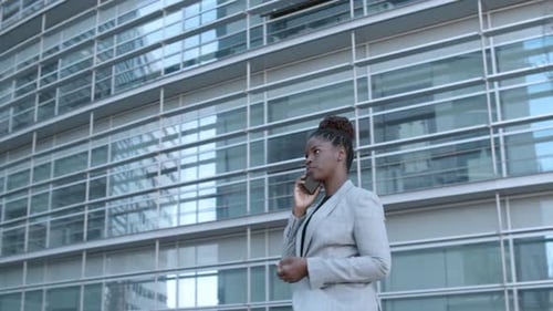 Woman in Suit Talking on Phone Outside Office