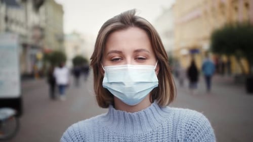 Young Woman Wearing Face Mask in the City