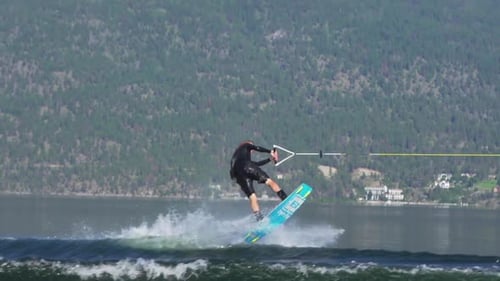 Young man wake boarding on a lake.
