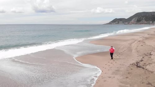 Woman running on sandy beach