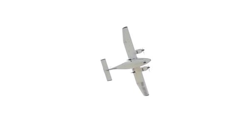 Small Airplane in Flight Against a White Sky