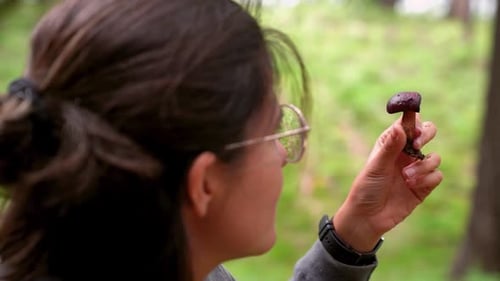 Woman with boletus mushroom in forest