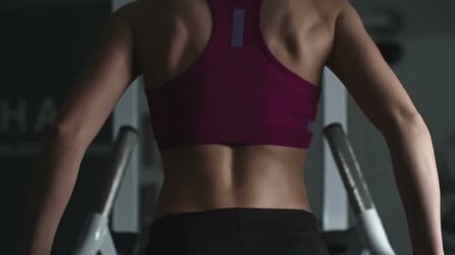 Woman Working Out at the Gym on Machine