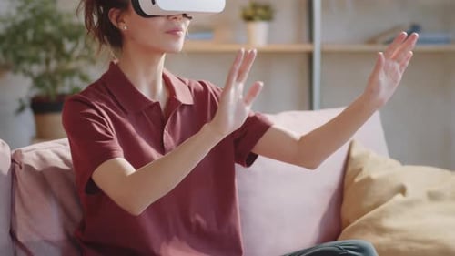 Woman Wearing VR Headset at Home on Couch