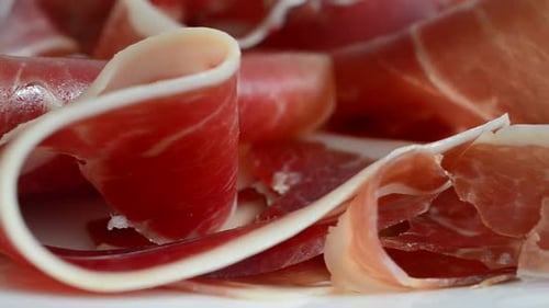 Jamon on the plate. Shooting in motion.