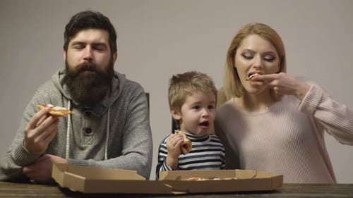Family Eating Pizza Together at Home
