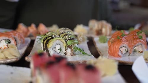Close-up, sets of sushi rolls on clay plates on the table