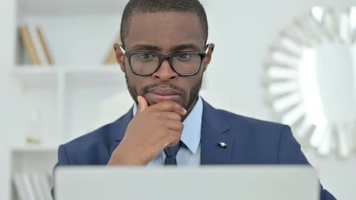 Professional Man Working on Laptop in Office