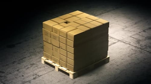 A stack of cardboard boxes on a pallet in the warehouse waiting for a forklift.