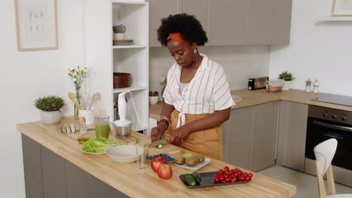 Woman Preparing Healthy Food in Bright Kitchen
