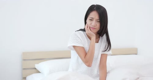 Woman feeling tooth pain