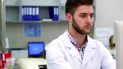 Focused Scientist Working on Computer in Laboratory