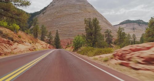 Road Curves Past Striking Mountain in Daytime