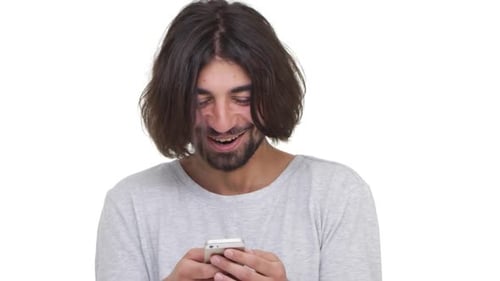 Man Laughing While Using his Cell Phone