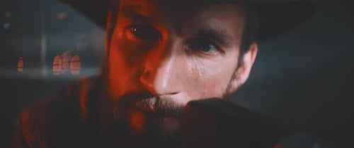 Man Films with Vintage Camera at Night