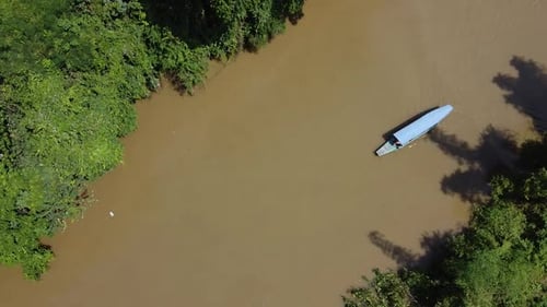 Stunning Aerial View of a Tourists Boat Sailing Along River at Sunset