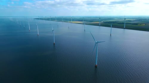 Offshore Windmill Park with Clouds and a Blue Sky Windmill Park in the Ocean Drone Aerial View with