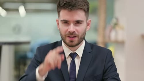Assertive Young Businessman with Pointing at the Camera