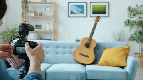 Young Man Plays Guitar for Camera at Home