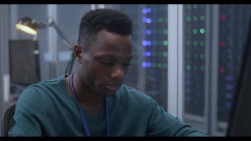 Tired Young Man Working in Data Center